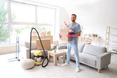 Erkek hademe odada yastıklı karton kutu tutuyor.