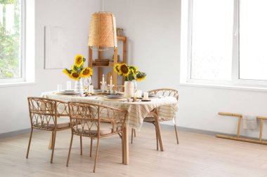 Oda da güzel ayçiçekleri olan yemek masası servis edildi.