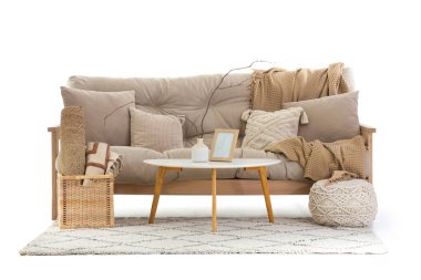 Masalı bej kanepe, puf ve beyaz arka planda halı.