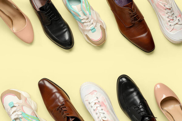 Different shoes on beige background. Top view