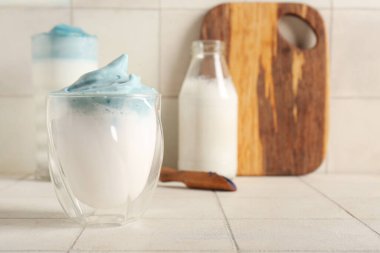 Bir bardak mavi dalgona kibrit latte. Fayans masasında, yakın plan.