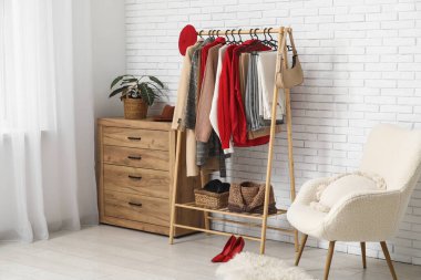Modern wardrobe with stylish winter clothes and accessories