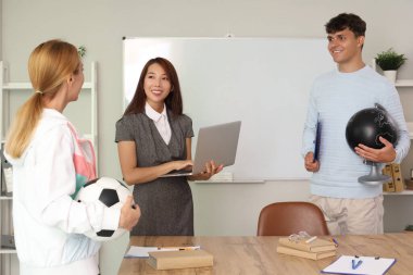 Teachers working in school office