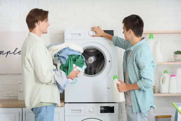 Stock image Male students doing laundry in dormitory