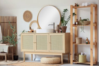 Banyonun içinde çekmeceler, ayna ve raf ünitesi var.