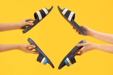 Sarı arka planda parmak arası terlikleri olan eller