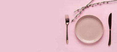 Table setting with pussy willow on pink background with space for text