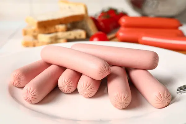 stock image Plate with tasty thin sausages and tomatoes, closeup