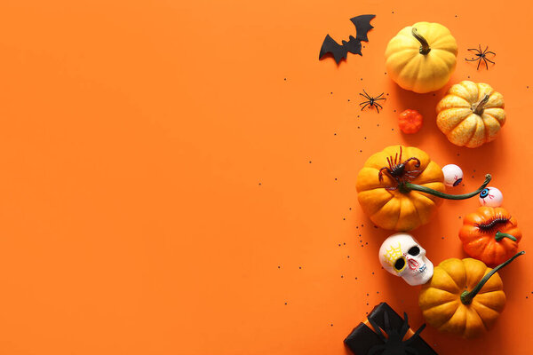 Halloween composition with fresh pumpkins on color background