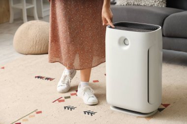 Woman with air humidifier at home