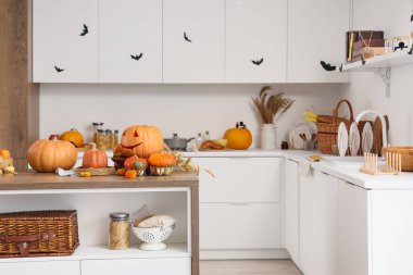 Cadılar Bayramı için tezgah, masa ve balkabaklarıyla dekore edilmiş hafif mutfağın içi.