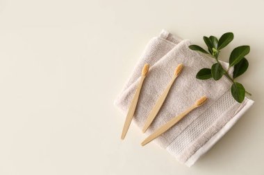Bambu diş fırçaları ve arka planda havlu, üst manzara.