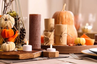 Şükran Günü yemeği için balkabakları ve mumlarla güzel bir sofra.