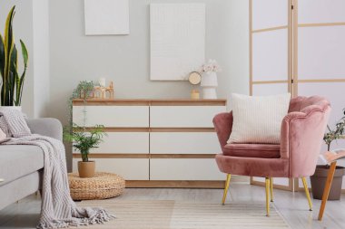 Oturma odasında yastıklı ve çekmeceli koltuk.