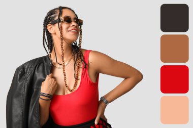 Hafif arka planda havalı bir Afro-Amerikalı kadın. Farklı renk desenleri