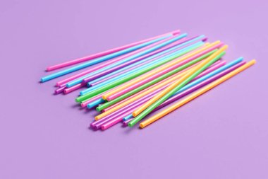 Mor arkaplanda farklı plastik pipetler