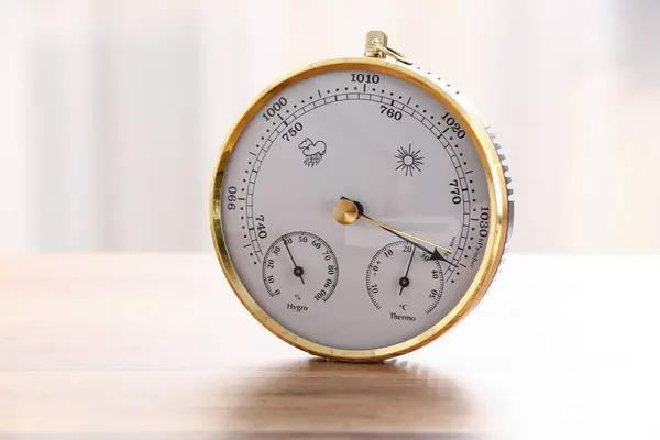 Stock image Aneroid barometer on wooden table in room, closeup