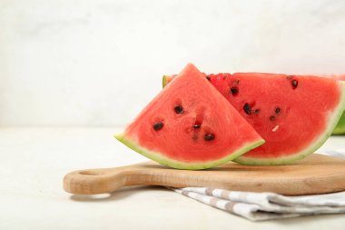 Hafif arka planda taze olgun karpuz parçaları olan tahta, yakın plan