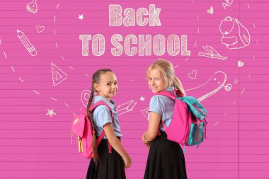 Küçük kızlar ve renkli arkaplan üzerine okula geri mesaj atın 