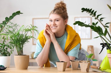 Yeşil bitkiler evde olan kadın