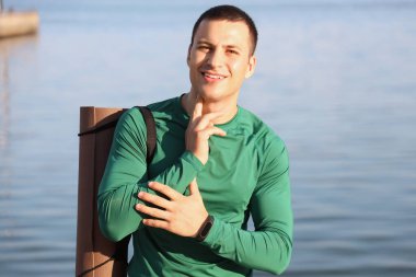 Sportif genç adam antrenmandan sonra nabzını kontrol ediyor.