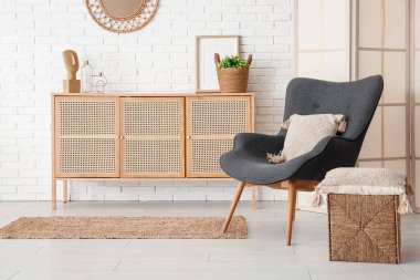 Modern oturma odası. Siyah koltuk, kabin ve katlanır ekran.