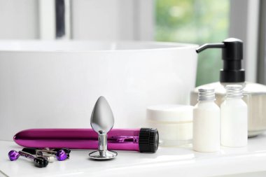 Sex toys on table in bathroom, closeup