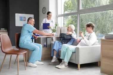 Elmalı bir grup doktor klinikte röntgen görüntülerini inceliyor.