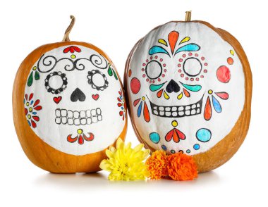 Pumpkins with painted skulls and flowers on white background. El Dia de Muertos clipart