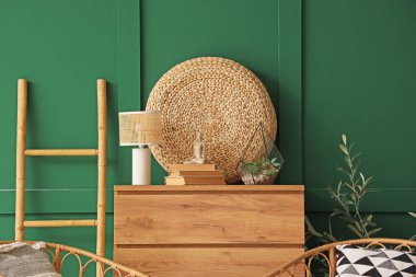 Odanın içinde ahşap klozet, rattan puf ve merdiven var.