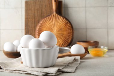 Beyaz masada çiğ tavuk yumurtası ile kase.