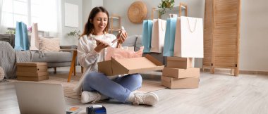 Evde paketleri açan güzel bir kadın. Kara Cuma indirimi