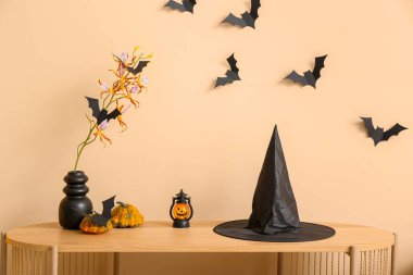 Oturma odasındaki rafta cadı şapkası olan Cadılar Bayramı dekoru.