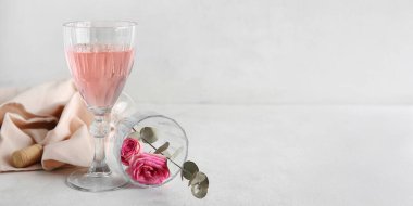 Açık arkaplanda pembe şarap ve güllerle kompozisyon metin için boşluk