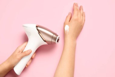 Pembe arka planda modern fotoğraf makinesi olan kadın elleri