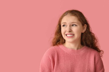 Portrait of ashamed young woman on pink background clipart