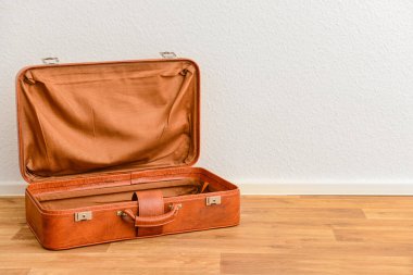 Odadaki kahverengi deri bavulu aç.