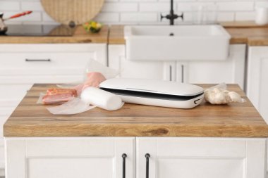 Mutfak masasında et ve mantarlı yemek için vakum mühür makinesi.