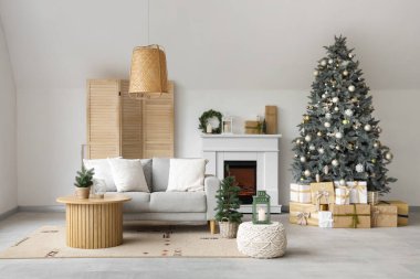Interior of modern living room with fireplace decorated for Christmas