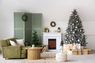 Interior of modern living room with fireplace decorated for Christmas
