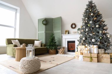 Interior of modern living room with fireplace decorated for Christmas