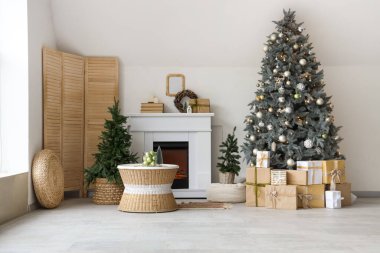 Interior of modern living room with fireplace decorated for Christmas