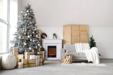 Interior of modern living room with fireplace decorated for Christmas