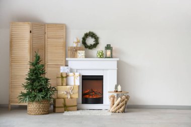 Interior of modern living room with fireplace decorated for Christmas