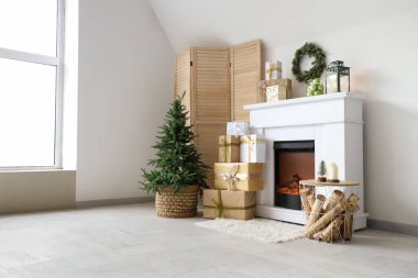 Interior of modern living room with fireplace decorated for Christmas