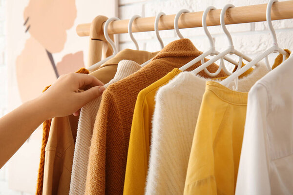 Woman with autumn clothes in room, closeup
