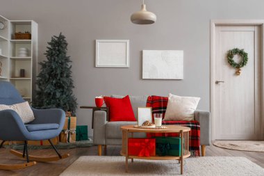 Oturma odasının içi Noel için kanepe ve masa ile dekore edilmiş.