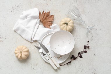 Beyaz arka planda taze balkabaklarıyla, dallarıyla ve sonbahar yapraklarıyla güzel bir masa.