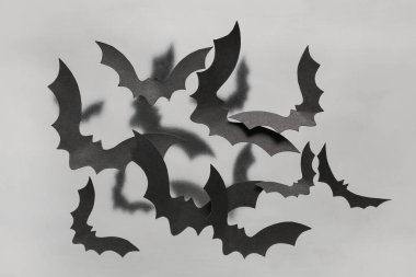 Gri arka planda Cadılar Bayramı partisi için kağıt yarasalar