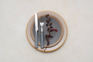 Beautiful table setting with rose hip berries and branch on white background clipart